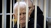 FILE - Ales Bialiatski, an imprisoned Belarusian Nobel Peace Prize laureate and head of the Belarusian Viasna rights group, sits in a defendant's cage during a court session in Minsk, Belarus, Jan. 5, 2023. 