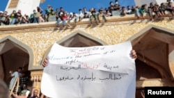 People who survived the deadly storm that hit Libya, protest outside the Al Sahaba mosque against the government in Derna, Libya on Sept. 18, 2023. 