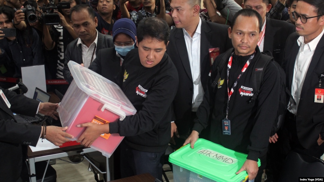 Tim kuasa hukum pasangan calon presiden dan wakil presiden nomor urut 03, Ganjar Pranowo dan Mahfud MD memberikan berkas dan dokumen permohonan Perselisihan Hasil Pemilihan Umum ke Mahkamah Konstitusi pada Sabtu (23/3) di Jakarta. (VOA/IndraYoga)