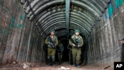 Israeli soldiers are seen in a tunnel the military says Hamas militants used to attack the Erez crossing, in the northern Gaza Strip, Dec. 15, 2023.