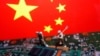 资料照：以中国国旗为背景的工人和半导体芯片图示。