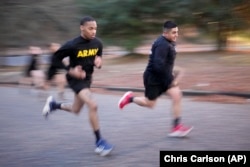 Army Staff Sgt. Daniel Murillo, right, runs uphill as part of his training at Ft. Bragg on Jan. 18, 2023, in Fayetteville, North Carolina. (AP Photo/Chris Carlson)