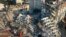 FILE - Rescue teams search for people as cranes remove debris from destroyed buildings in Antakya, southeastern Turkey, Feb. 10, 2023.