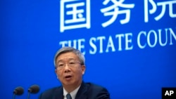 FILE - Yi Gang, governor of the People's Bank of China, speaks during a press conference at the State Council Information Office in Beijing, March 3, 2023.