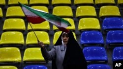 A supporter of a group of candidates waves an Iranian flag during an election campaign rally ahead of the March 1 parliamentary elections, in Tehran, Iran, Feb. 28, 2024. 