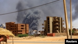 (FILE) Smoke rises above buildings after an aerial bombardment during clashes between Sudan's Army and the Rapid Support Forces.