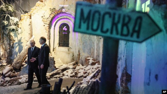 Russian President Vladimir Putin, left, accompanied by Victory Museum Director Alexander Shkolnik, visits the Victory Museum in Moscow, Russia, June 22, 2023.