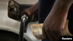 FILE - Motorists pumps fuel into his vehicle in the commercial capital Blantyre in this picture taken March 26, 2012.