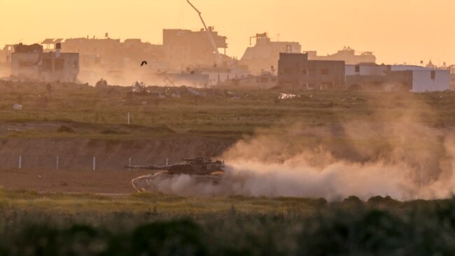 This picture taken from a position in southern Israel near the border with the Gaza Strip shows an Israeli armored vehicle rolling along the border on March 3, 2024.