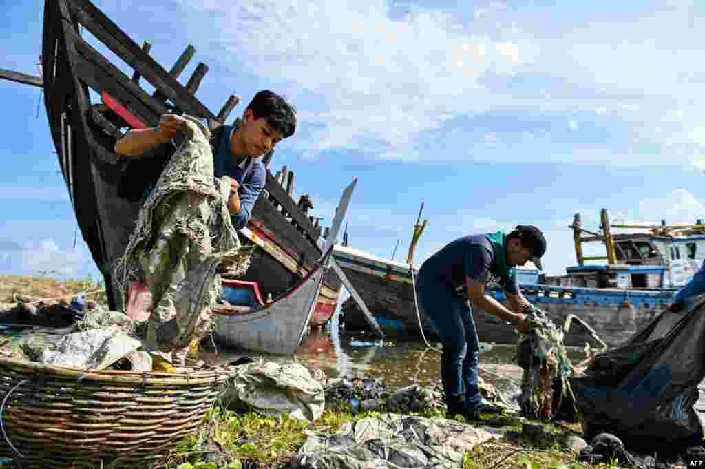 University students clean up plastics and other debris washed ashore at a port in Banda Aceh, Indonesia.
