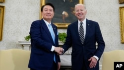 FILE - U.S. President Joe Biden greets South Korea's President Yoon Suk Yeol in the Oval Office of the White House, April 26, 2023, in Washington. The two met again on the sidelines of the NATO summit in Washington on July 11, 2024.