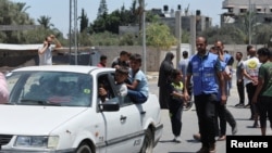 Displaced Palestinians, who fled north Gaza after they were ordered by Israeli army to move southward, amid the Israel-Hamas conflict, arrive in Nuseirat in the central Gaza Strip, July 11, 2024.