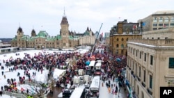 FILE - Truck drivers and others protest COVID-19 pandemic restrictions in Ottawa, Ontario, Feb. 12, 2022. 