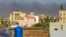 Smoke rises behind buildings in Khartoum amid ongoing fighting between the forces of two rival generals, on May 16, 2023.