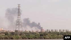 FILE - A picture taken from Omdurman shows smoke billowing north of Khartoum, Sudan, July 22, 2023, as fighting between the country's army and a rival military faction continues.