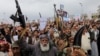 FILE - Protesters, mainly Houthi supporters, rally in Sanaa, Yemen, to show support to Palestinians in the Gaza Strip, April 26, 2024. Yemen's Houthi rebels said on Tuesday that they struck a Portuguese-flagged container ship in a drone attack in the Indian Ocean. 