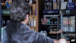 People buy alcohol in a liquor store in Baghdad, Iraq, March 9, 2023. The Iraqi government started enforcing a 2016 ban on alcoholic beverages this month, a move that many minority Christians see as an attempt to marginalize their community.