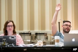 Maggie Lorenz, left, and Kevin Moch participate in a meeting of the word panel to finalize the 2023 Scripps National Spelling Bee words on May 28, 2023, at National Harbor in Oxon Hill, Md.