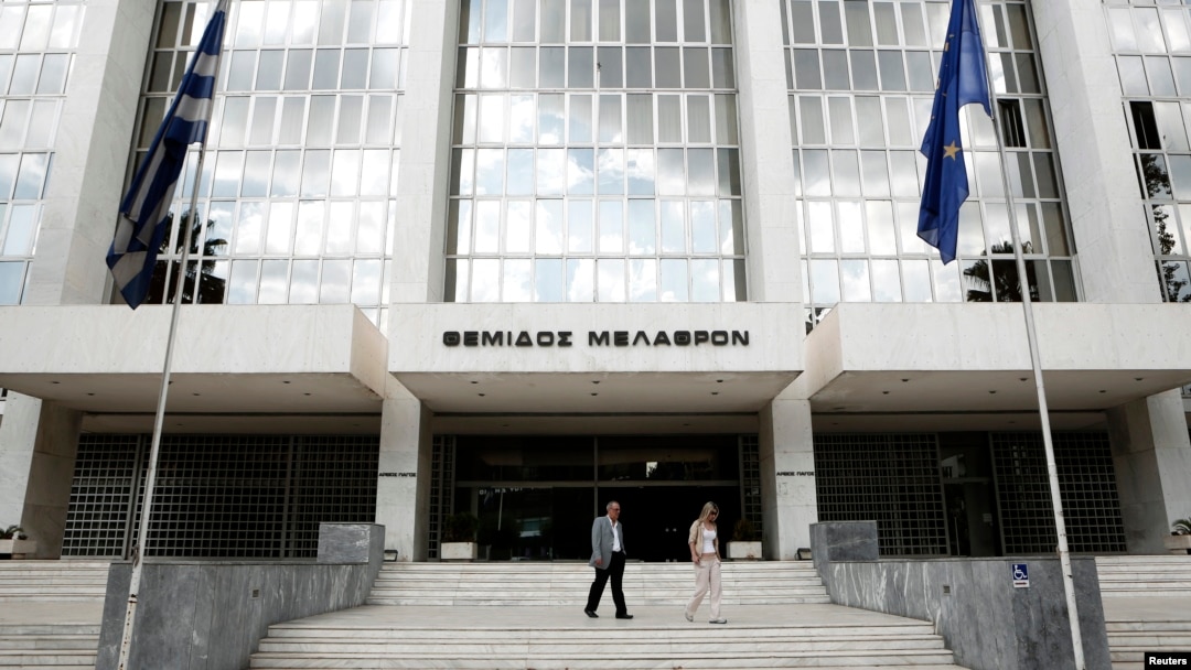 FILE - People walk outside Greece's Supreme Court in Athens, Sept. 17, 2012. The court assembly voted nine to one to disqualify Ilias Kasidiaris and his party, called The Greeks, from the May 21 polls.