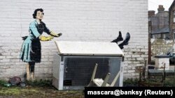 An artwork depicting violence against women, painted by street artist Banksy for the occasion of Valentines Day, is seen on a wall in Margate, Kent, Britain, Feb. 14, 2023 in this picture obtained from social media.