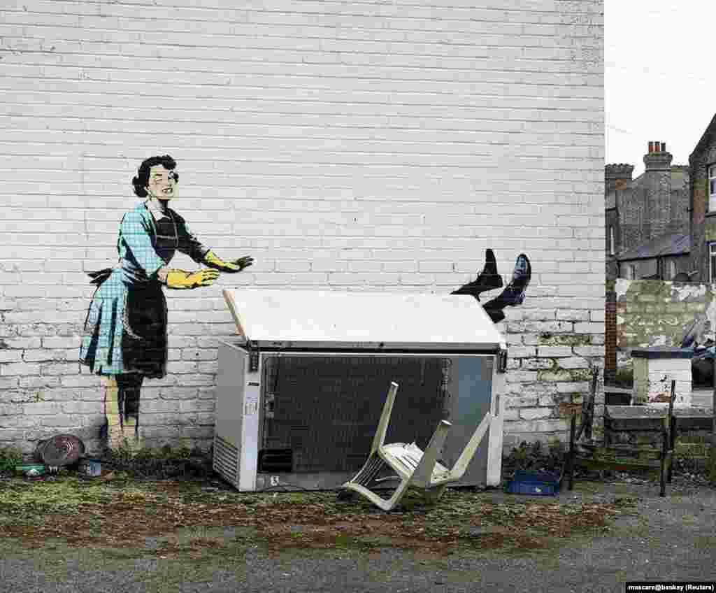 An artwork depicting violence against women, painted by street artist Banksy for the occasion of Valentines Day, is seen on a wall in Margate, Kent, Britain, in this picture obtained from social media.