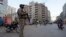 FILE - Paramilitary soldiers stand guard along road side to ensure security in Karachi, Pakistan, April 9, 2024.