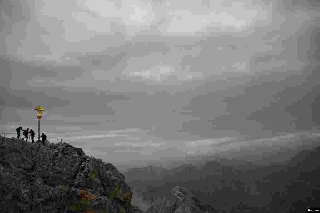 Mountaineers walk on Germany&#39;s highest peak, the Zugspitze mountain near Garmisch-Partenkirchen.