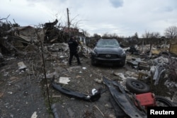 A police officer inspects a residential area heavily damaged during a Russian missile and drone strike, amid Russia's attack on Ukraine, in the city of Kamianske, Dnipropetrovsk region, Ukraine March 29, 2024.