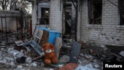 FILE - A stuffed toy bear is seen amid the wreckage of a building destroyed during Russia's attacks on Ukraine, in the village of Kamyanka, in Ukraine's Kharkiv region, Sept. 22, 2022.