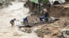 FILE - Men salvage parts from their destroyed home following heavy rains caused by Cyclone Freddy in Blantyre, southern Malawi, March 15, 2023. 