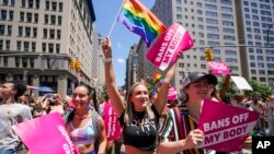 FILE - Revelers with Planned Parenthood march down Fifth Avenue during the annual NYC Pride March, on June 26, 2022, in New York.