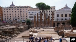 Rome's Mayor Roberto Gualtieri, left, and Bulgari CEO Jean-Christophe Babin, second from left, talk to journalists after inaugurating new walkways and lighting at four temples that date as far back as the 3rd century B.C., June 19, 2023.