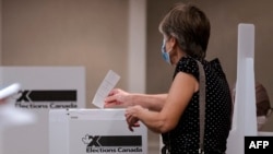 FILE - People cast their ballots at the Delta Hotel on voting day for the 2021 Canadian election in Montreal, Quebec on September 20, 2021.