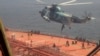 In this frame grab from video footage released April 28, 2023, by the Iranian Navy, Iranian marines rappel onto the Advantage Sweet, a Marshall Islands-flagged oil tanker's deck in the Gulf of Oman.