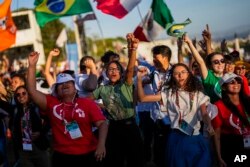 FILE - Young people dance during a concert during the 37th World Youth Day festivities in Lisbon, Portugal, on Aug. 3, 2023.