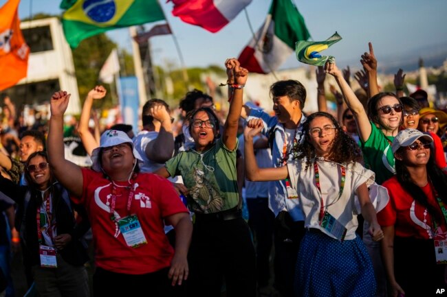 FILE - Young people dance during a concert during the 37th World Youth Day festivities in Lisbon, Portugal, on Aug. 3, 2023.
