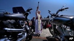 FILE - Bishop Emeritus of Sanggau, West Borneo, Giulio Mencuccini, 77, blesses the participants of a pilgrimage of bikers to the St. Gabriele dell' Addolorata sanctuary in Isola del Gran Sasso in central Italy, June 18, 2023.
