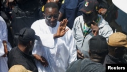 Senegal's ruling coalition candidate Amadou Ba gestures after casting his vote during the presidential election at the polling station of Ecole HLM Grand Medine in Dakar, Senegal, March 24, 2024.