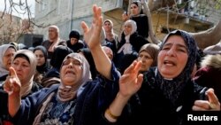 Women react during the funeral of three Palestinian militants, who were killed during an Israeli operation, in Jaba' town near Jenin, in the Israeli-occupied West Bank, March 9, 2023. 