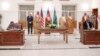 Saudi Foreign Minister stands along with other officials as representatives of the Sudanese army and rival paramilitary Rapid Support Forces sign an agreement for a seven-day ceasefire.