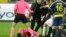 Referee Halil Umut Meler lies on the ground after being punched by MKE Ankaragucu president Faruk Koca, center, at the end of the Turkish Super Lig soccer match between MKE Ankaragucu and Caykur Rizespor in Ankara, Dec. 11, 2023. 