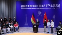 In this photo released by Xinhua News Agency, German Chancellor Olaf Scholz takes part in a dialogue with students at Tongji University's Jiading Campus in Shanghai, China, April 15, 2024. 