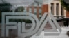 FILE - A U.S. Food and Drug Administration building is seen behind FDA logos in Silver Spring, Maryland, on Aug. 2, 2018.