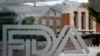 FILE - A U.S. Food and Drug Administration building is seen behind FDA logos in Silver Spring, Maryland, Aug. 2, 2018.