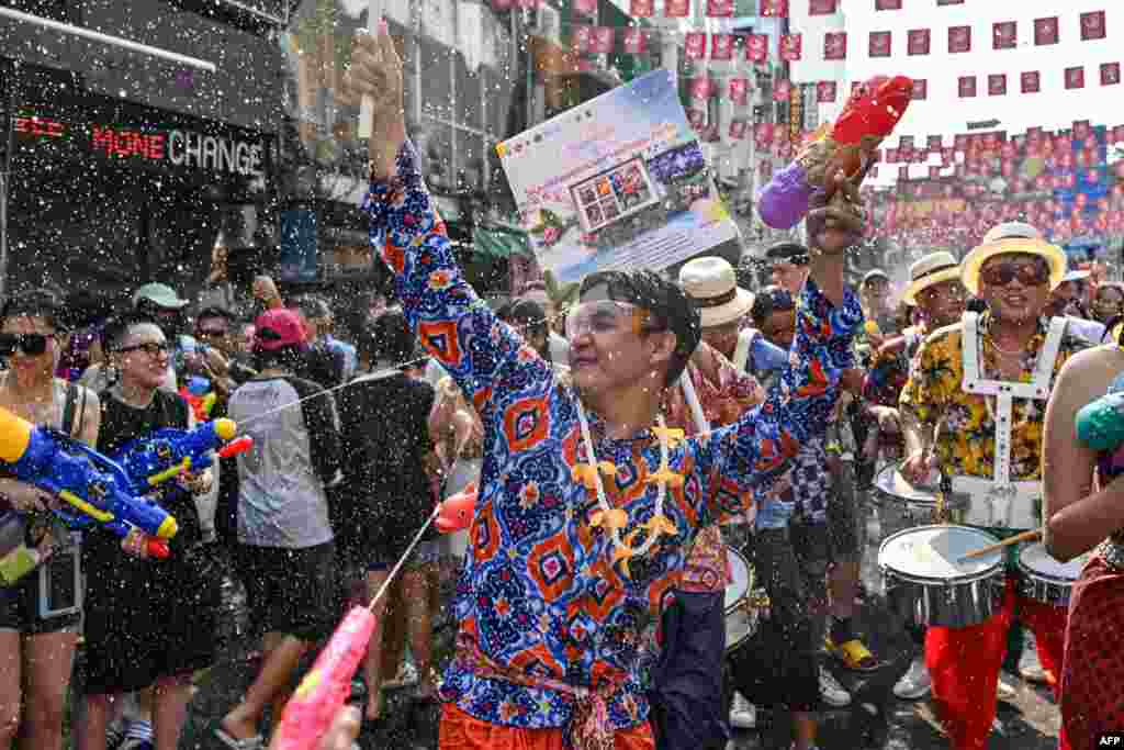 Revelers take part in mass water fights on the eve of Songkran, or Thai New Year, on Khao San Road in Bangkok, Thailand.