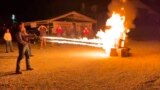 In this frame grab from video provided by Debbie McFarland, state Sen. Bill Eigel torches a pile of cardboard boxes at a “Freedom Fest” event in Defiance, Mo., Sept. 15, 2023. 