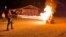 In this frame grab from video provided by Debbie McFarland, state Sen. Bill Eigel torches a pile of cardboard boxes at a “Freedom Fest” event in Defiance, Mo., Sept. 15, 2023. 