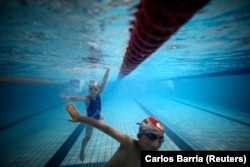 FILE - Kids swim in the deep end at Hangzhou Chen Jinglun Sports School Natatorium in Hangzhou, China, August 2, 2012. (REUTERS/Carlos Barria)