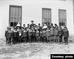 Photo of uniformed Native American students, priest and nuns at St. Labre Indian school in Montana. Courtesy Montana Historical Society.