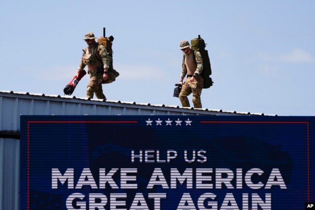 Security gets in position before Republican presidential nominee former President Donald Trump speaks at a rally, in Asheboro, North Carolina, Aug. 21, 2024.